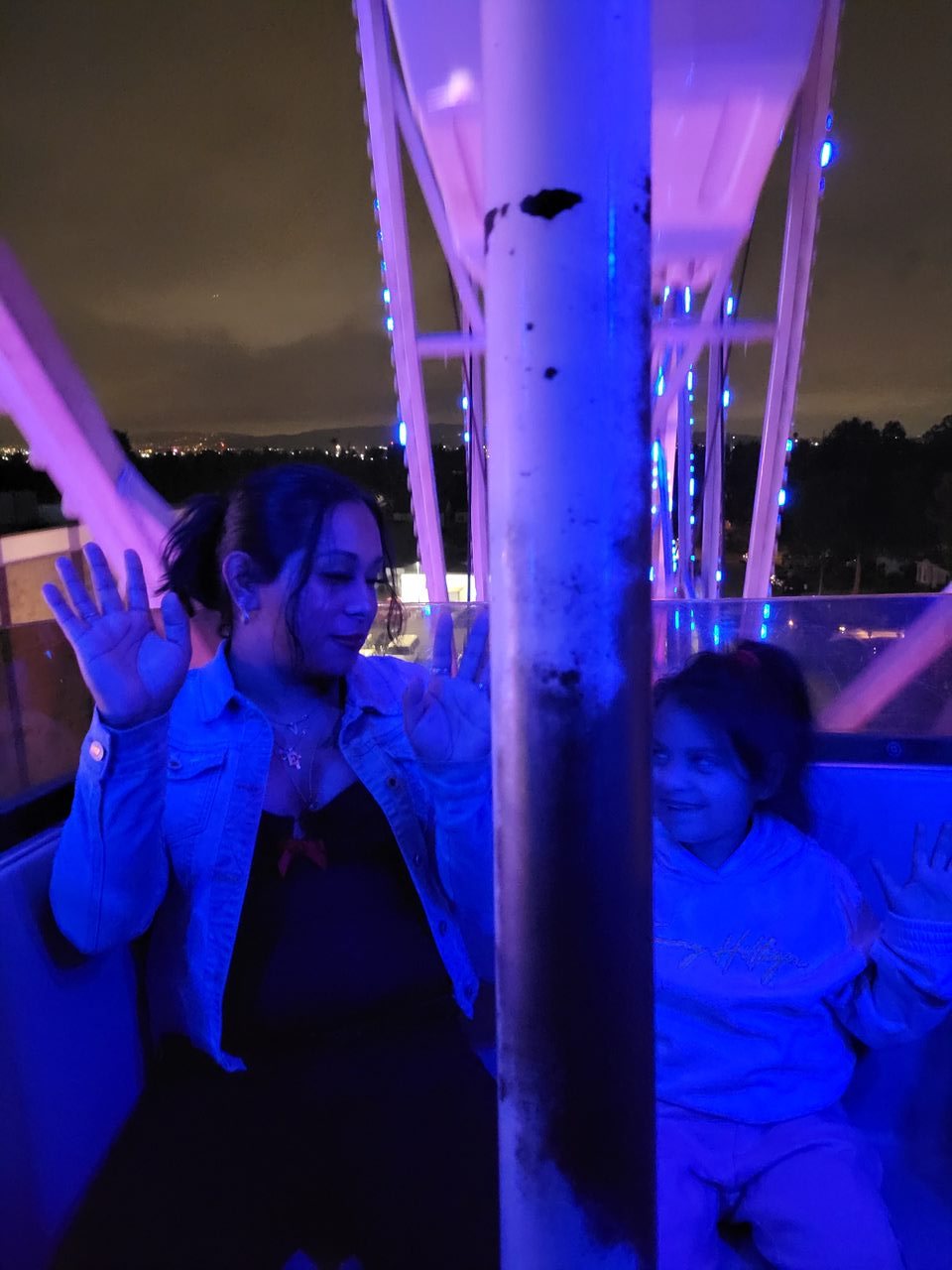 Ellie and Isabella on a ferris wheel at night